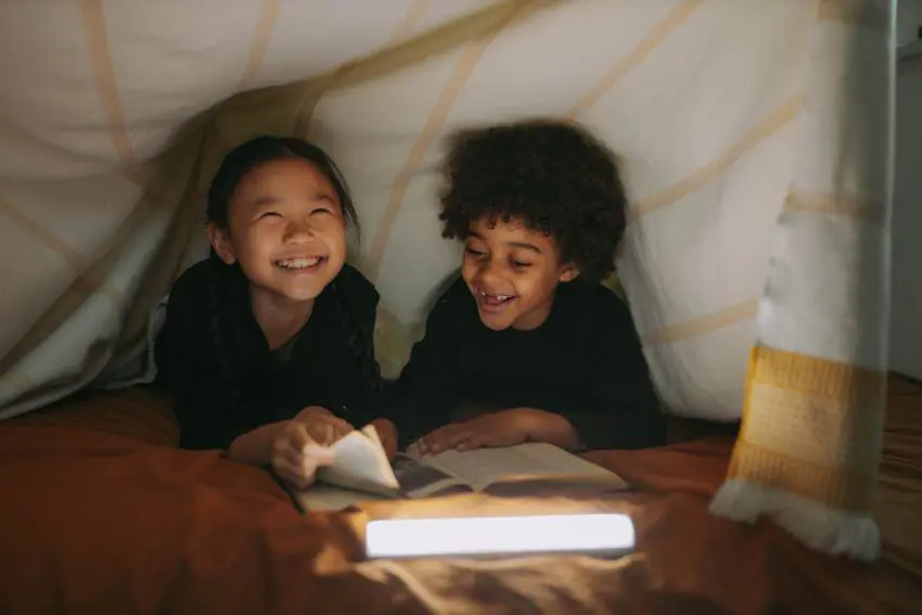 two children reading a book together